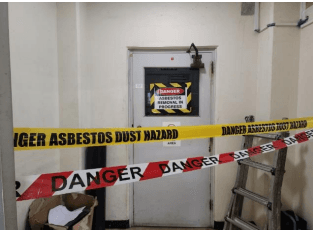 Quarantined asbestos contamination area with signage
