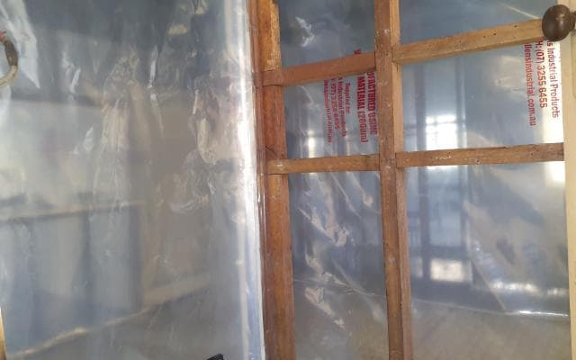 Friable asbestos enclosure with negative-pressure unit